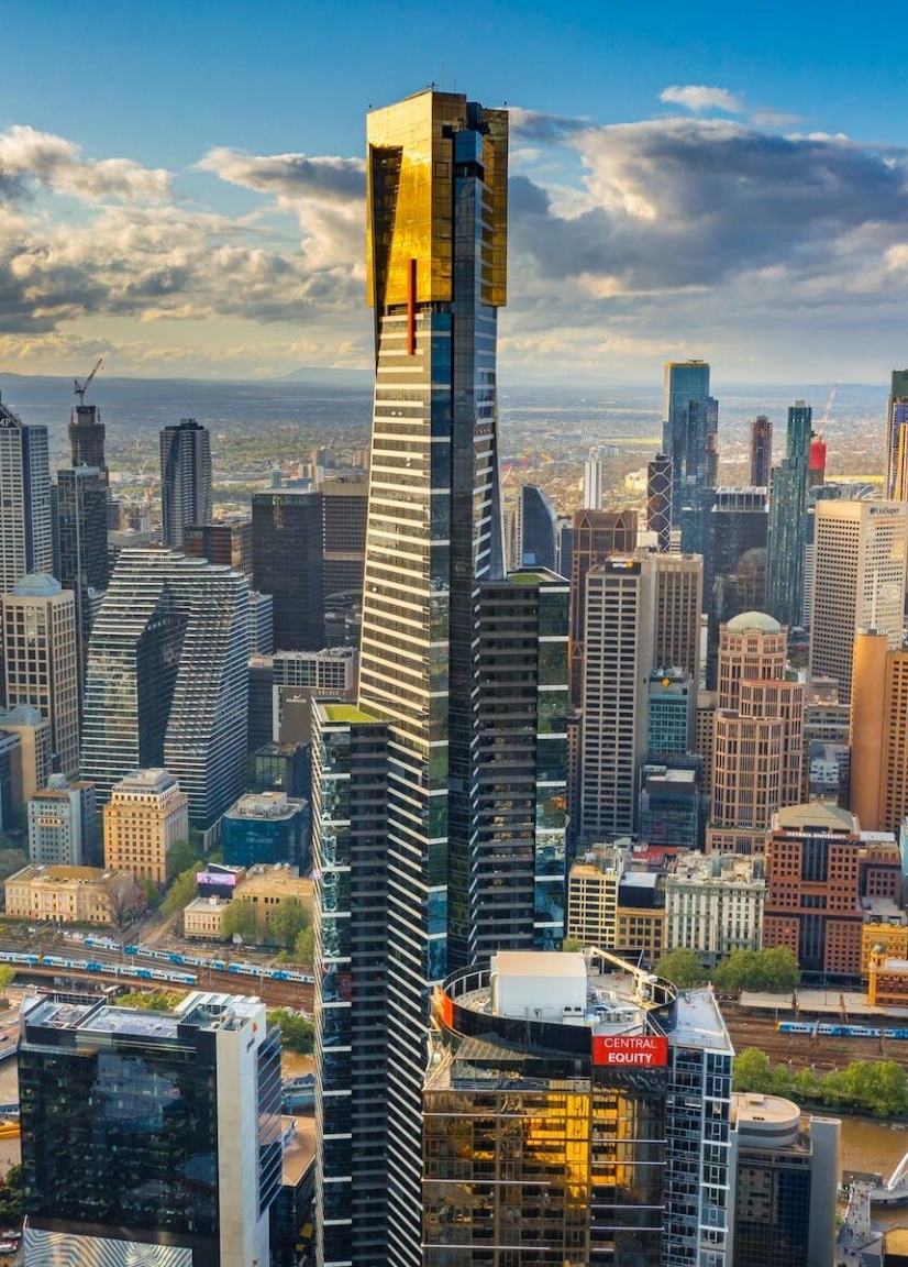 Aerial view of the Melbourne skyline with a tall gold-topped skyscraper at its centre